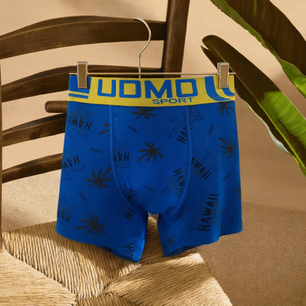 UOMO SPORT Hawaii surf-print boxer brief GMUO-7228AMH on a wooden clip hanger with palm-tree print visible