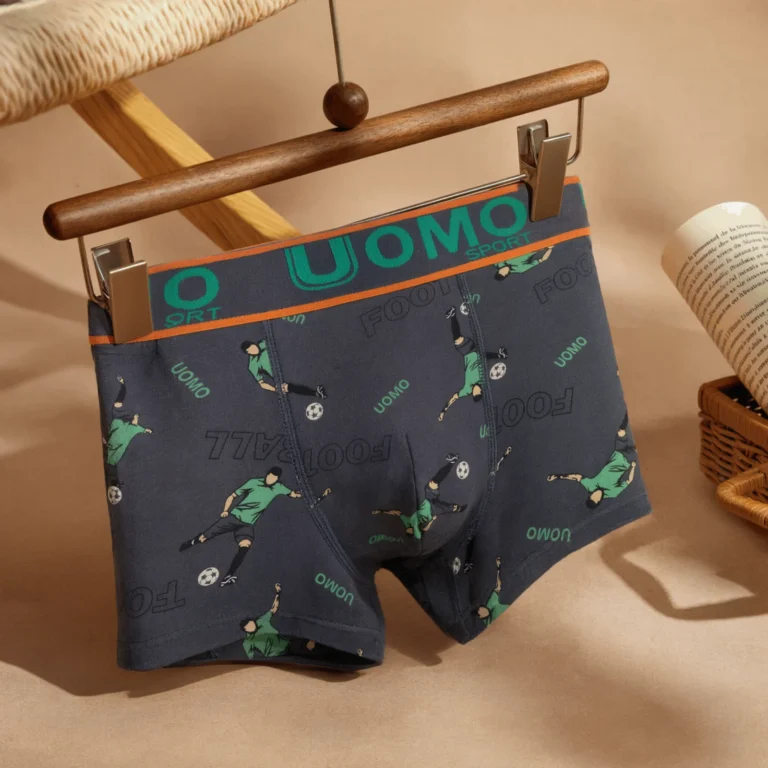 UOMO SPORT football-print boxer brief GMUO-7231AMH on a wooden clip hanger showing the orange-striped waistband