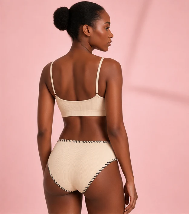 Ribbed cotton Brazilian brief in cream, back view on model