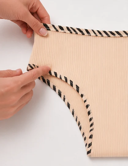 Contrast zebra binding and ribbed cotton waistband stretched by hand