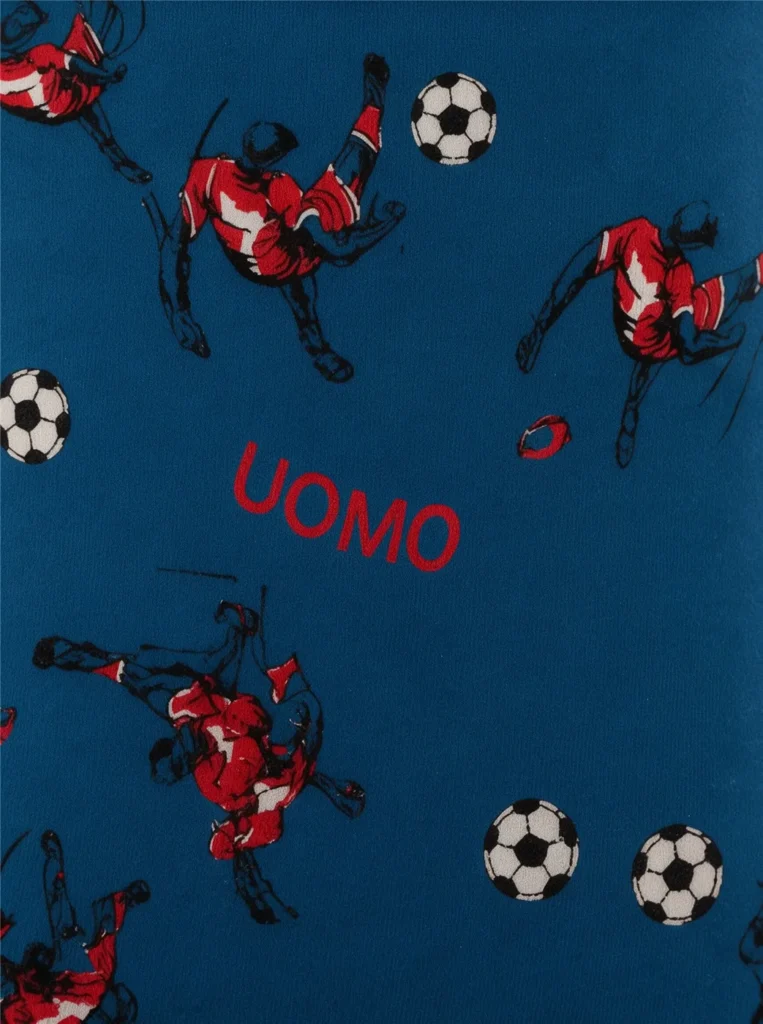 Close-up of the all-over football print on GMUO-7141AMH cotton jersey: red players, footballs and UOMO wordmark